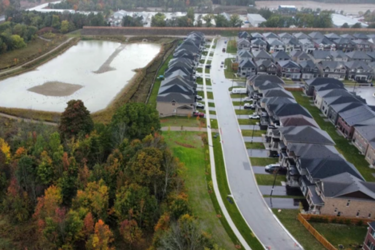 Aerial view of a neighbourhood with a pond.