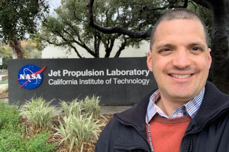 Headshot of Chris Heirwegh next to NASA sign