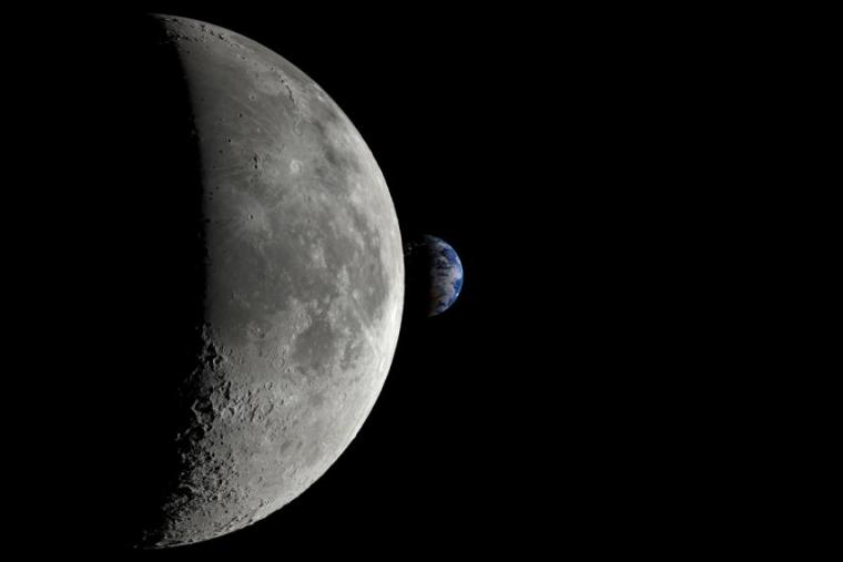 The moon is large in the foreground as half of it is covered in shadow, as the earth in seen in the distance