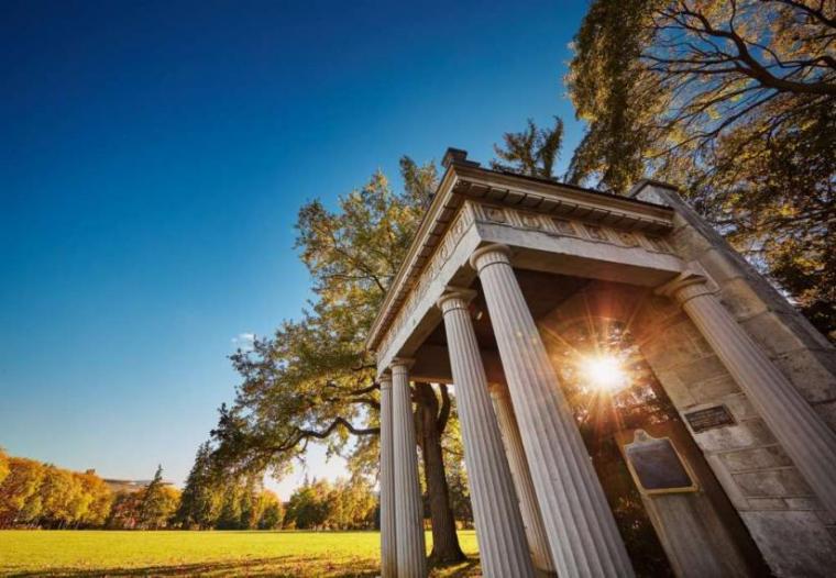 Artistic image of structure on U of G grounds with sun and blue skies