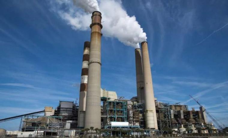 A power plant with smoke stacks.