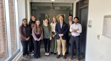 The participants of the U of G CEPS 3MT® competition pose and smile for a picture in a hallway of Reynolds building.