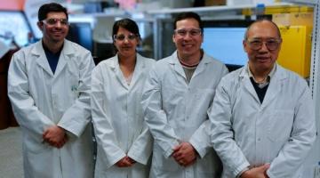 Dr. A. Elsayed, S. Abner, Dr. E. Mena-Morcillo, and Dr. A. Chen pose in lab coats in a lab
