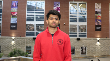 Headshot of Vinay Joshy with SSC Atrium in background. 