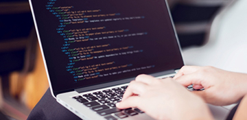 Student coding on computer