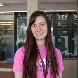 Kat Idzik smiling in a pink Actua shirt