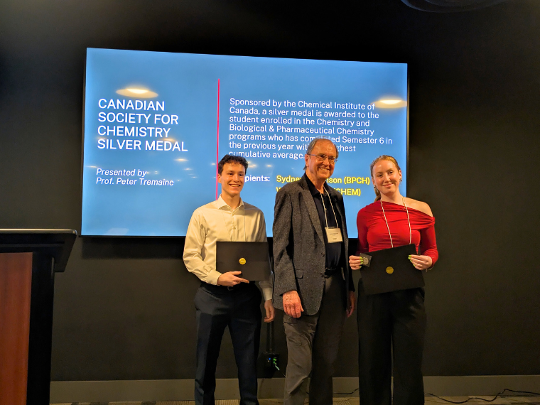William Berecz (left), and Sydney Simonson (right) each accept the Canadian Society for Chemistry Silver Medal from Prof. Peter Tremaine (middle).