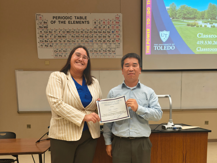 Natalie Condino (left) holds a certificate for her award with Jianglong Zhu (right).