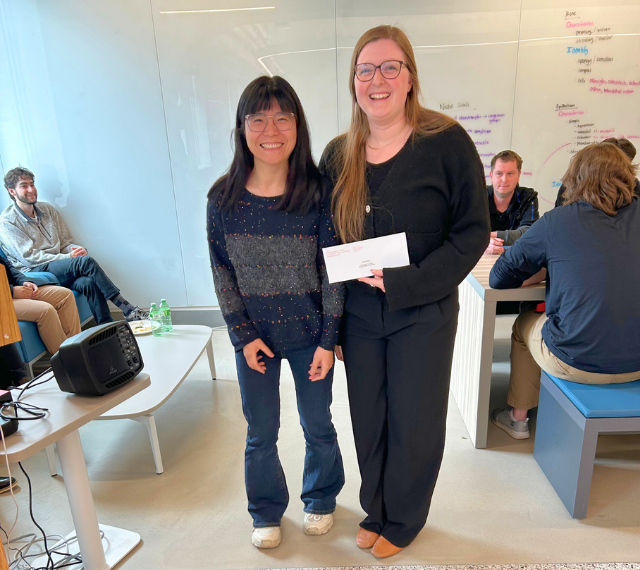 Rui Huang (left) stands with graduate student Megan Black as she accepts her award.