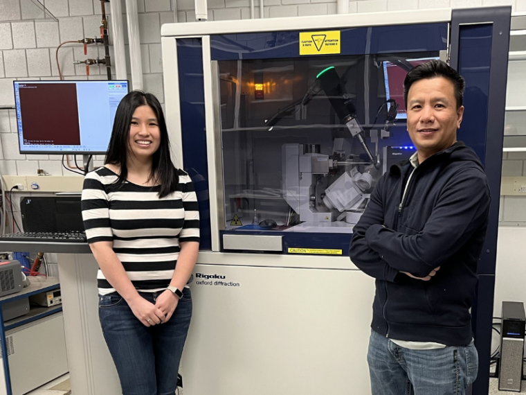 Researchers stand on either side of the new Rigaku Synergy-S Single Crystal Diffractometer 