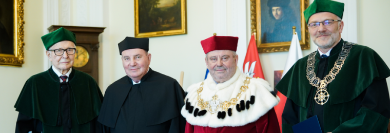 Four scholars, including Dr. Jacek Lipkowski, stand in regalia at formal award ceremony.