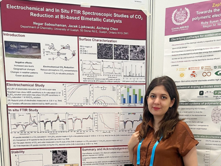 Negar Sabouhanian stands in front of her award winning research poster.