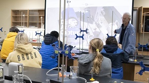 Dr. Reed presents to students in a laboratory.