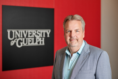 Robert Devries the CIO at the University of Guelph with the University of Guelph cornerstone in the background.
