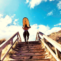 Student carrying a surf board up stairs