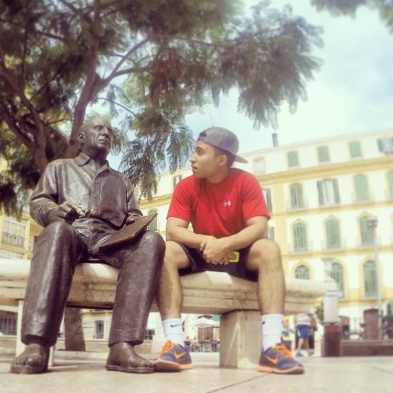 Student sitting beside a statue