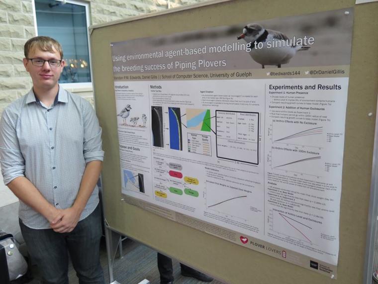 Computer Science Student Presenting Research Poster 