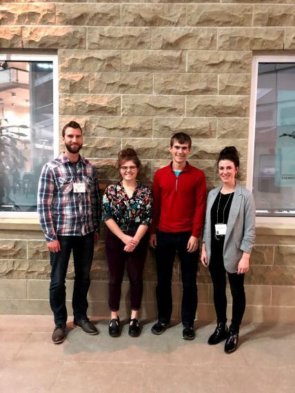 Students Maddie Gabriel and Issac Wismer (centre) receiving the Adknown scholarship from Tim Schmitt and Ashley Monoogian