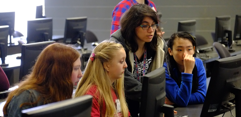 Four females working on a computer 