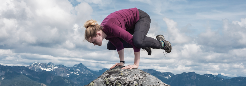 Mia balancing on the top of a mountain