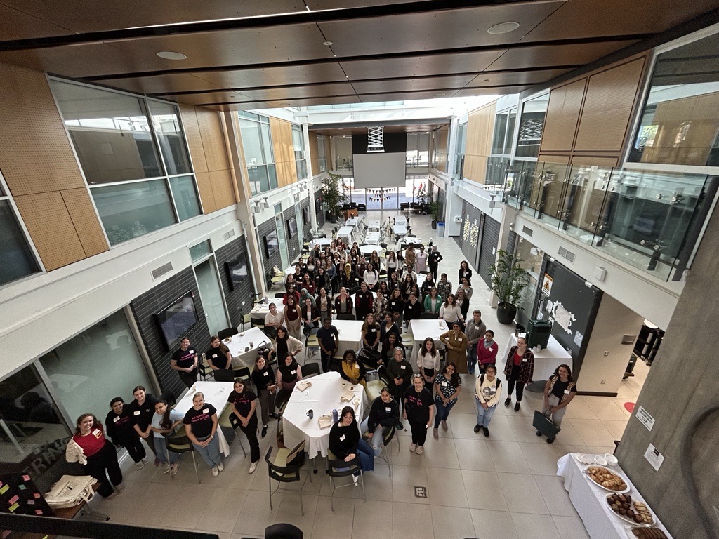 Group photo of women attending a RISE conference in the Albert A. Thornborough atrium.