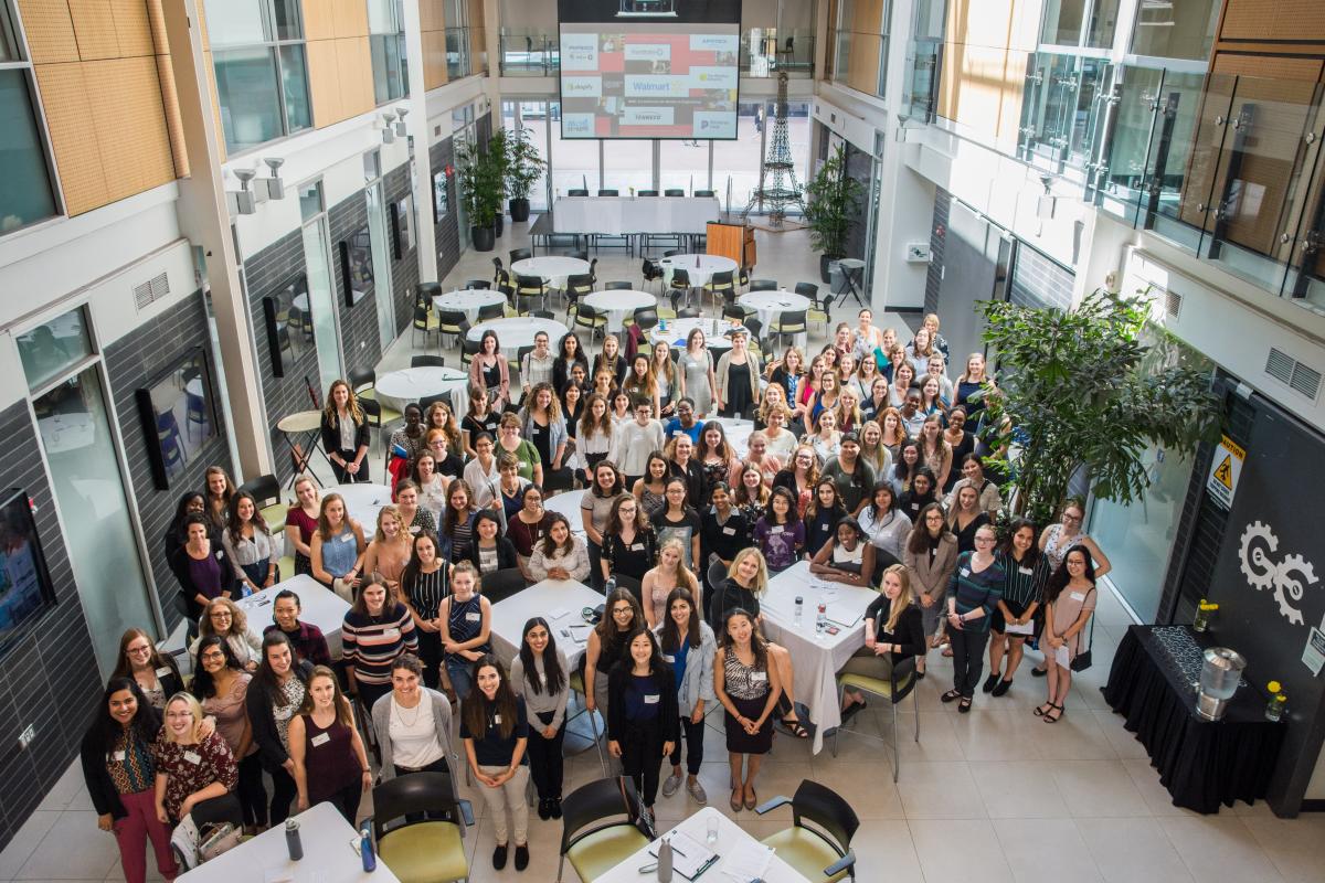 Group photo of women attending a RISE conference in the Albert A. Thornborough atrium.