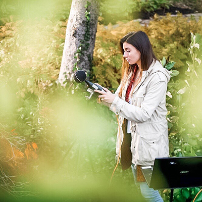 female student holding an air quality device