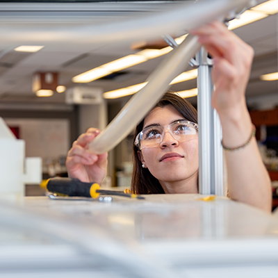 female student adjusting a tub on a device