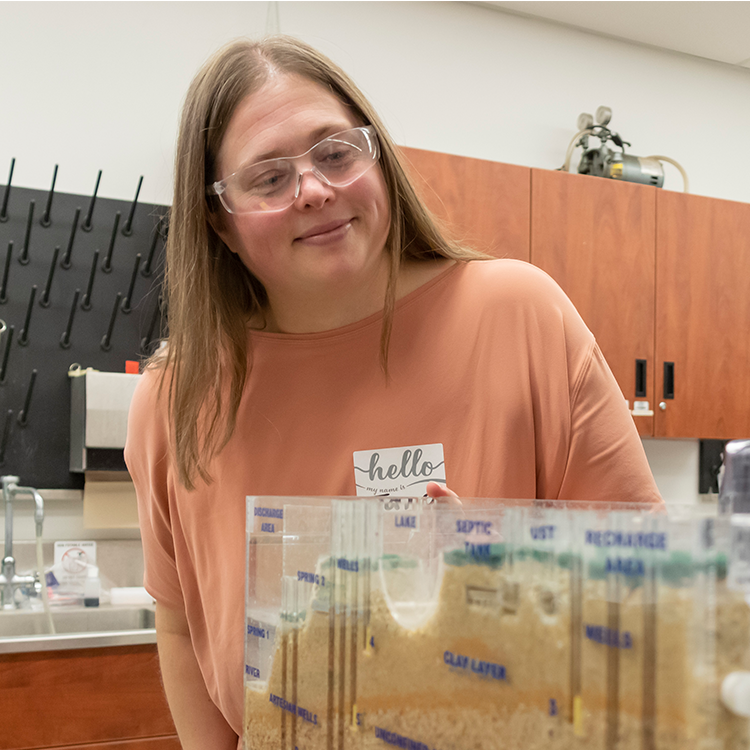 Jana Levison looking at a model of a ground water table 