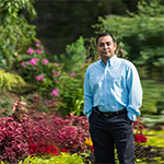 Animesh Dutta standing in a garden