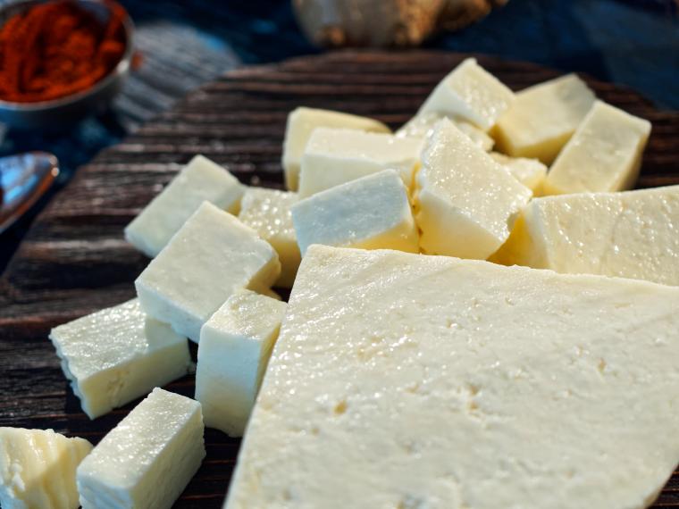 Soft cheese on black wooden board