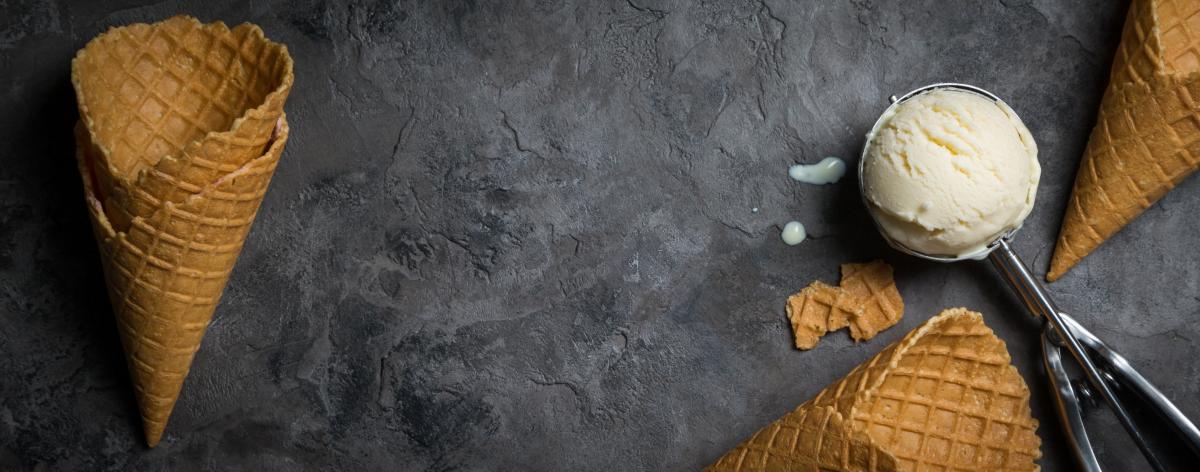 Ice cream and waffle cones on marble background