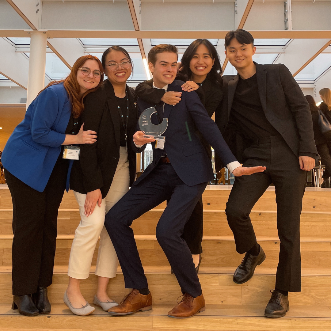 Photo of five students standing excited to win an award