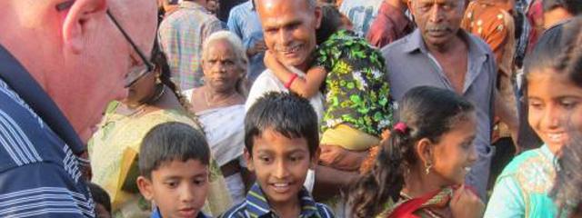 Joe Barth speaks with a group of locals in India
