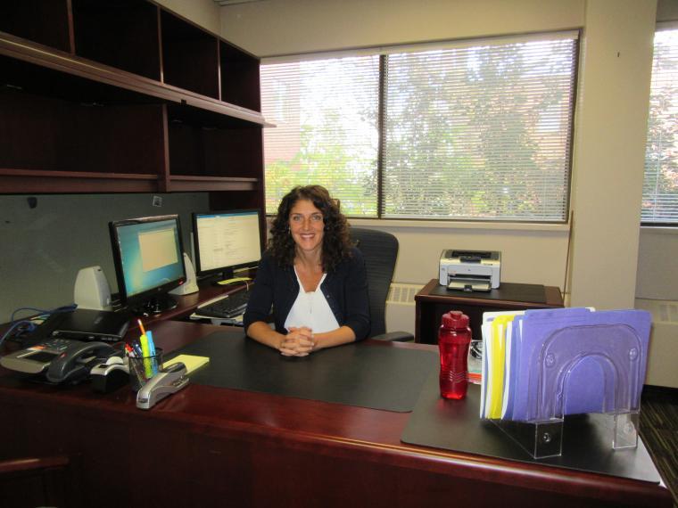 Barb Piccoli sitting at her desk