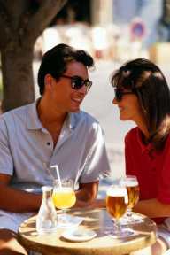 Photo of a couple drinking and laughing together