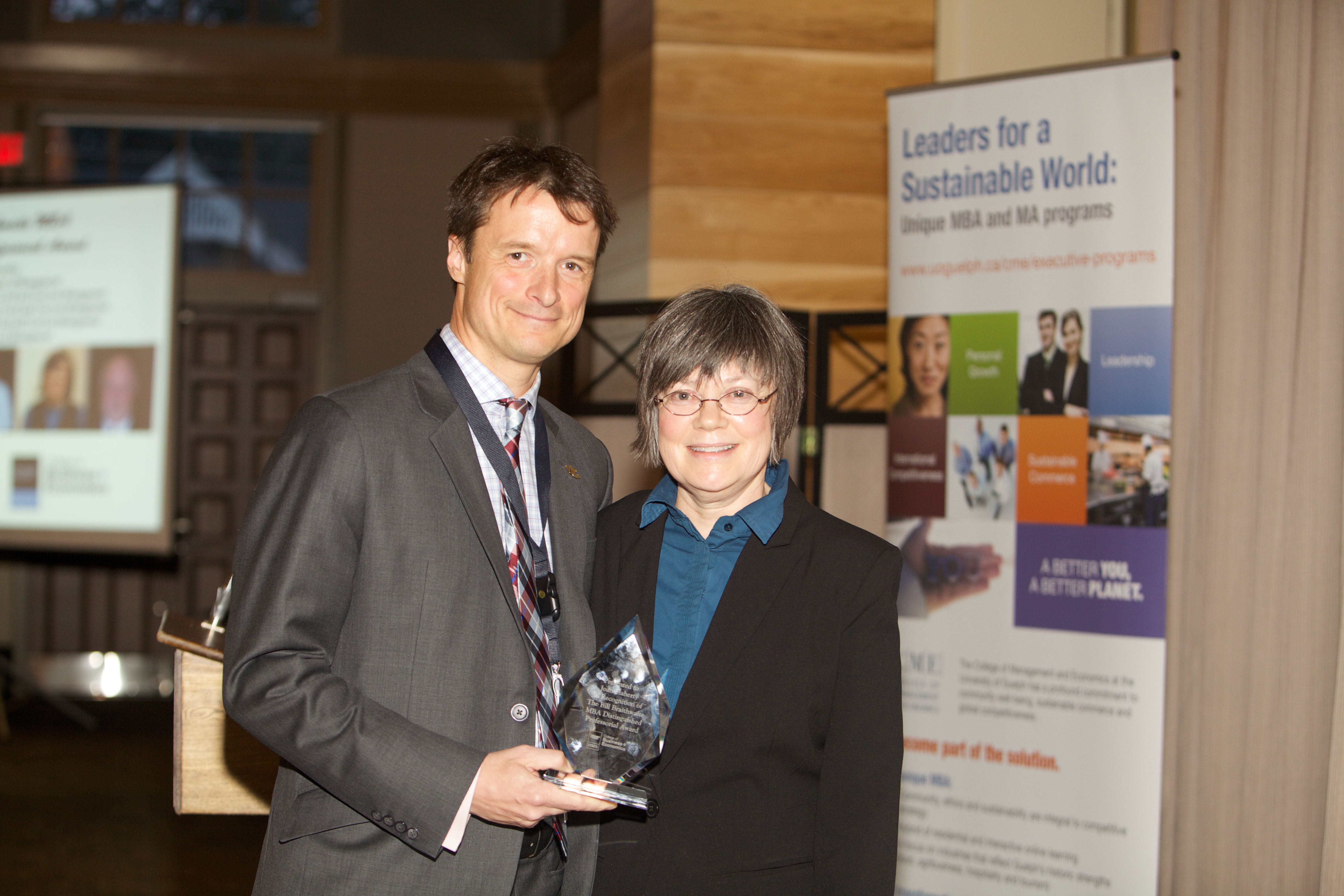 Sylvain Charlebois presenting the Bill Braithwaite award to Joan Flaherty