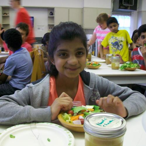 Student from Chris Hadfield Public School enjoying a salad she just prepared