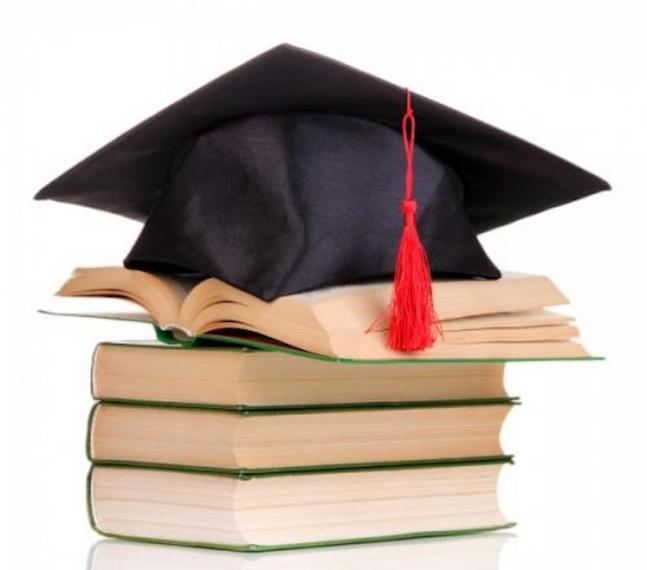 An image of a graduate cap atop a stack of books