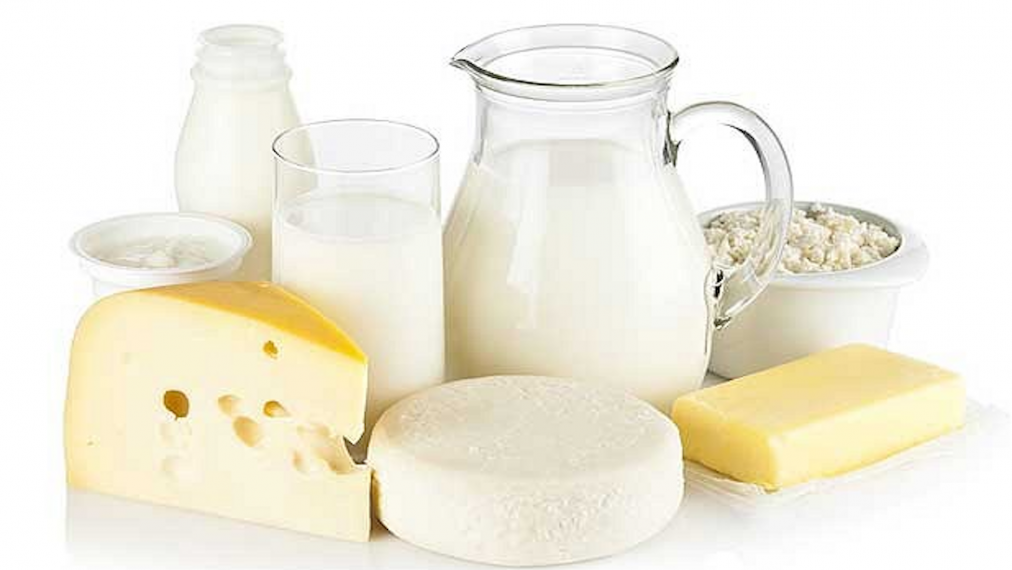 A photograph of dairy products including milk and cheese.