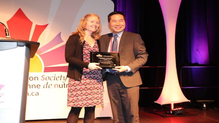 A photograph of Dr. David Ma presenting Dr. Alison Duncan with the CNS Volunteer Leadership Award.