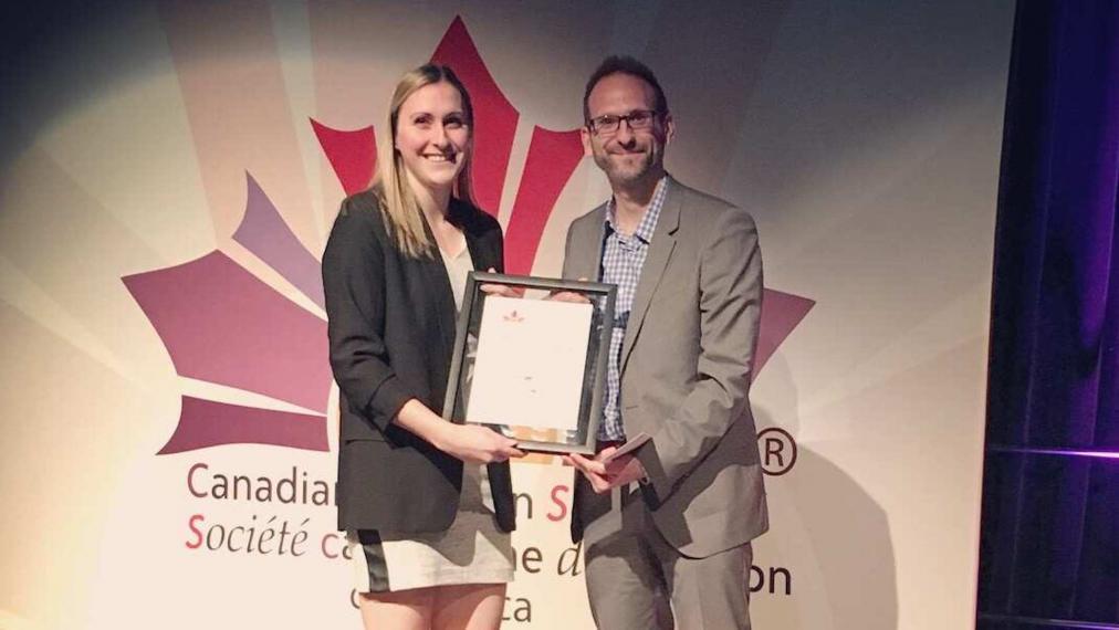 A photograph of Brittany MacPherson receiving a CNS Award