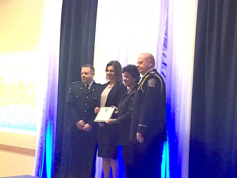 A photograph of Dr. Lorraine Jadeski and Premila Sathasivam being presented with a plaque by paramedics