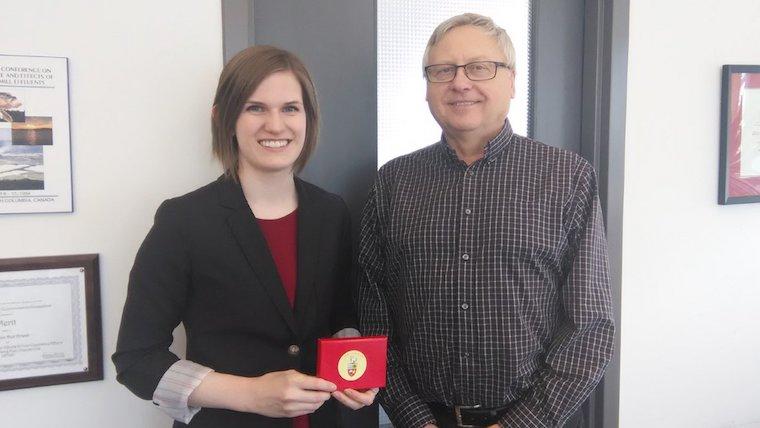 A photograph of Sandra Clark receiving an award.