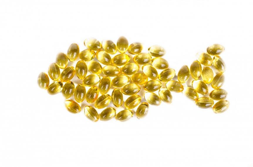 An image of omega-3 capsules arranged into a fish shape