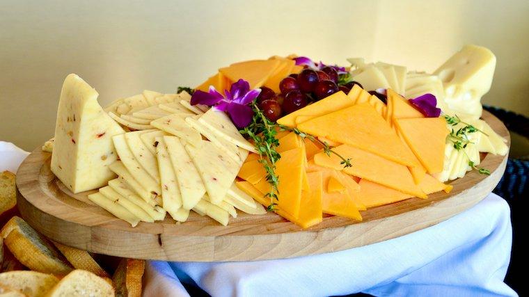 A plate with different types of cheese on it.