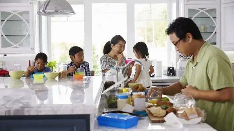 Family preparing a meal in the kitchen.