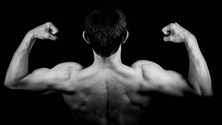 A photograph of a man flexing his muscles