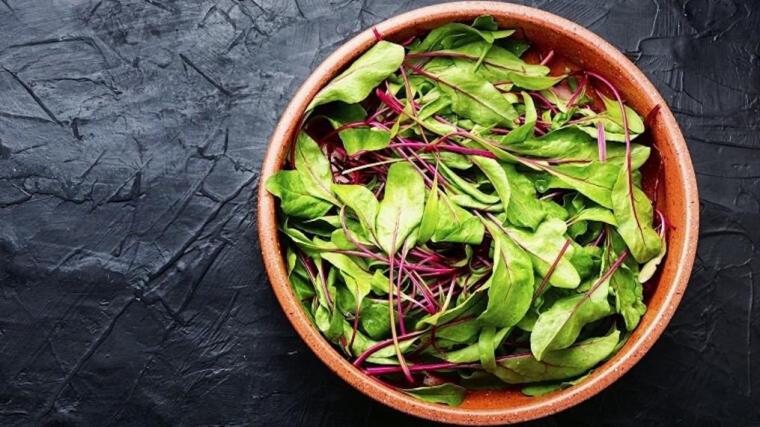 A bowl of leafy greens.