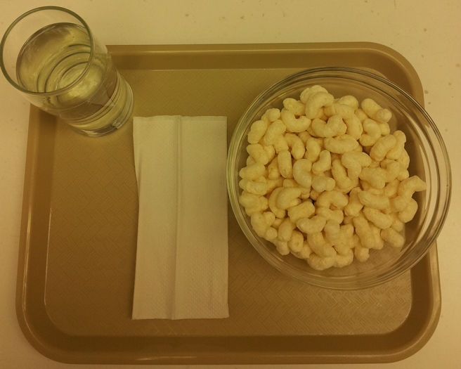 Serving of millet extruded snack in bowl to be served to participants.